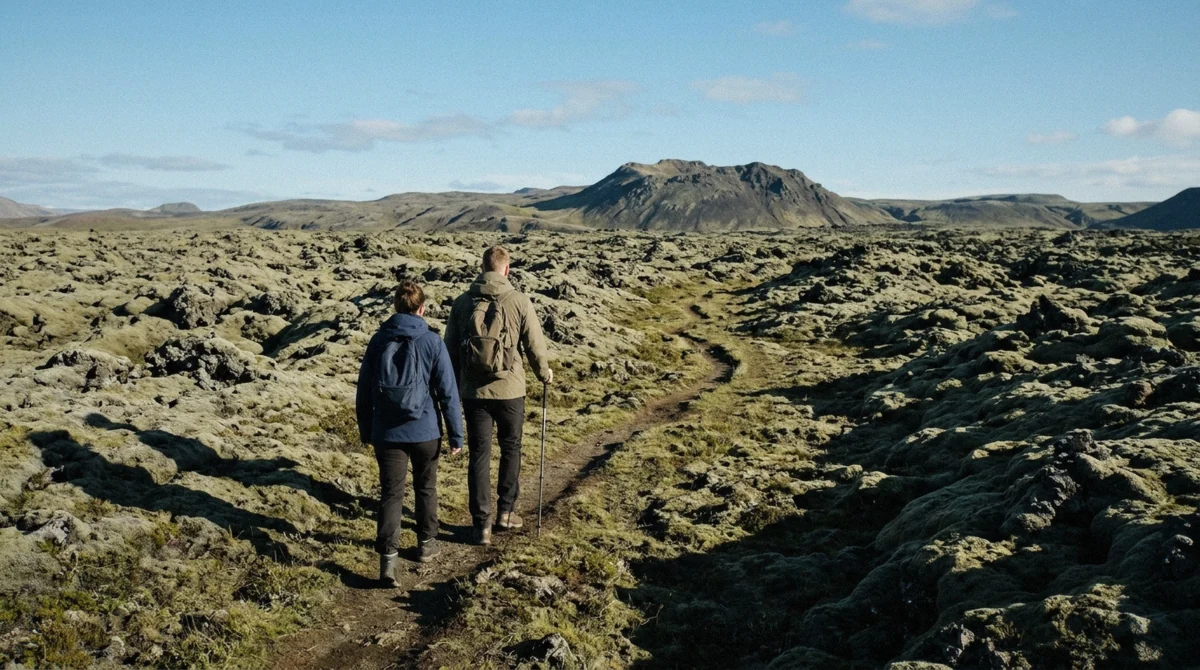 Hikers crossing the moss-covered lava field on the free walk to Thrihnukagigur without a tour, Blafjoll, Iceland